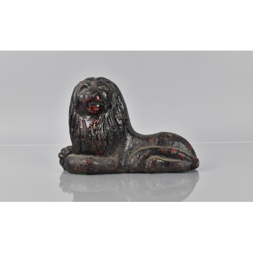 78 - A 19th Century Cast Iron Doorstop in the Form of a Recumbent Lion having Remnants of Red Paint Decor... 