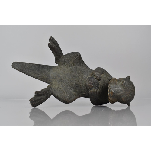 108 - Phil Vanderlei (American) A Bronze Study of an Otter, Modelled Floating on Back with Sea Urchin Held... 