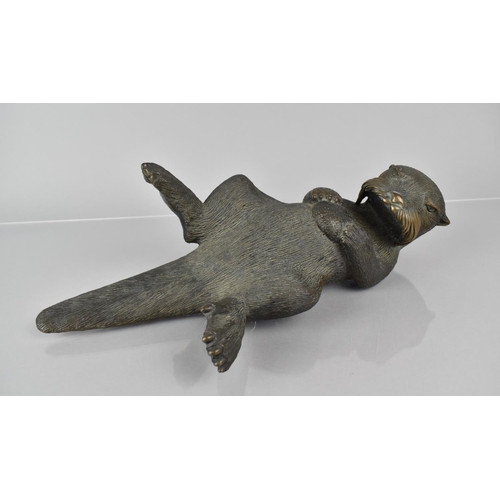 108 - Phil Vanderlei (American) A Bronze Study of an Otter, Modelled Floating on Back with Sea Urchin Held... 