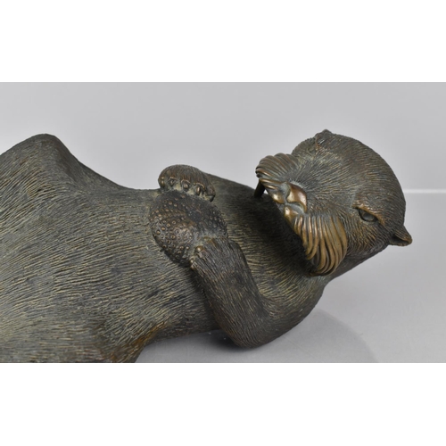 108 - Phil Vanderlei (American) A Bronze Study of an Otter, Modelled Floating on Back with Sea Urchin Held... 