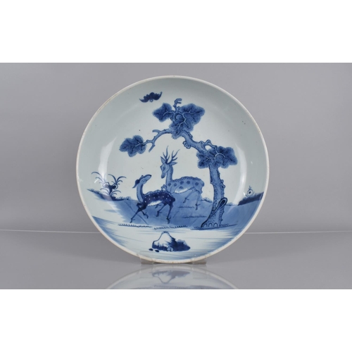 355 - A 19th Century Chinese Blue and White Shallow Dish Decorated with Deer beside Water and Tree, 29cms ... 