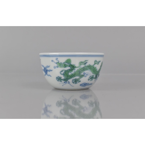 340 - A Chinese Porcelain Doucai Cup/Tea Bowl, Decorated with Dragons Chasing Flaming Pearl, Six Character... 