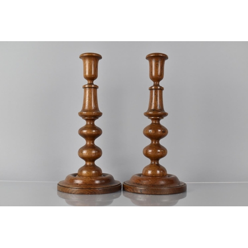 19 - A Pair of 19th Century Treen Turned Oak Candlesticks with Bobbin Turned Shafts over Circular Bases, ... 