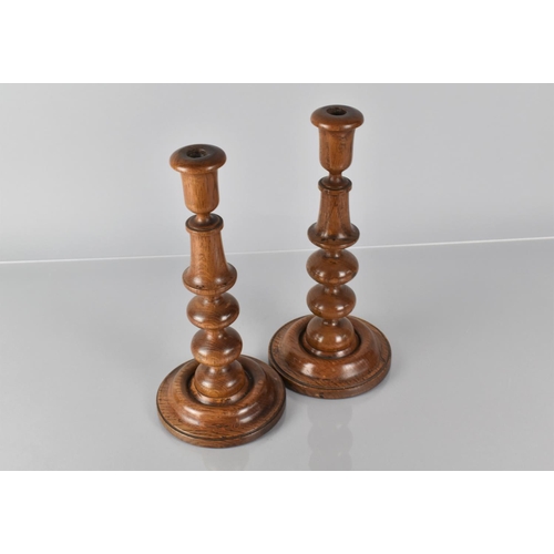 19 - A Pair of 19th Century Treen Turned Oak Candlesticks with Bobbin Turned Shafts over Circular Bases, ... 