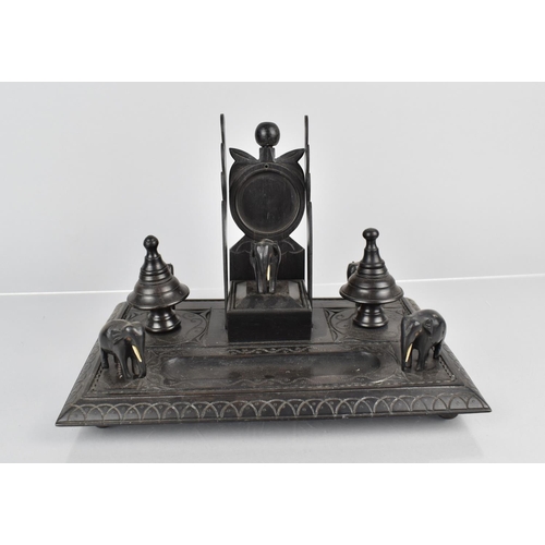 9 - A 19th Century Indian Carved Ebony Ink Stand with Turned Inkwells, Pen Rests, Watch Holder and Five ... 