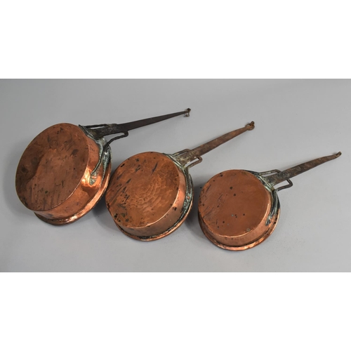 114 - A Collection of Three North African Copper Saucepans with Metal Handles