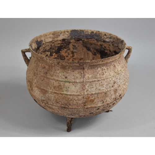 380 - A Weathered Metal Tripod Cauldron with twin Handles, 28cms Diameter