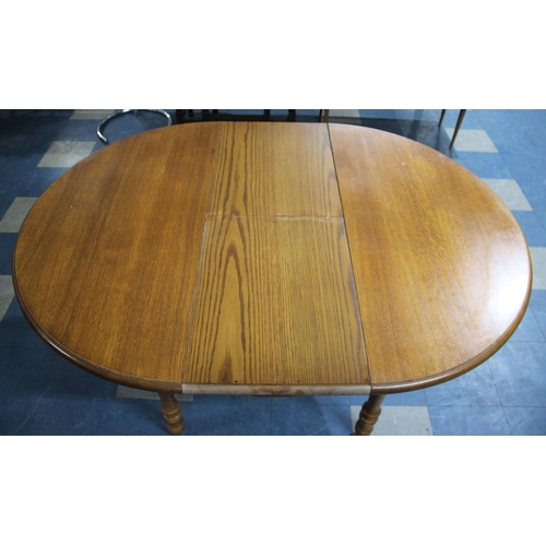 478 - A Modern Oak Extending Oval Dining Table, 148x108cms Max