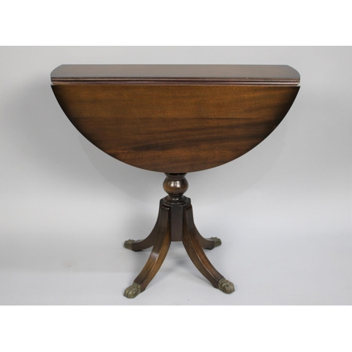 68 - A Modern Mahogany Drop Leaf Circular Coffee Table on Four Scrolled Supports on Claw Feet, 29cms Wide