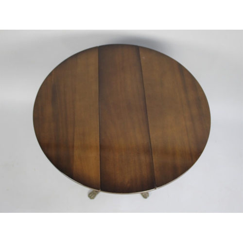 68 - A Modern Mahogany Drop Leaf Circular Coffee Table on Four Scrolled Supports on Claw Feet, 29cms Wide