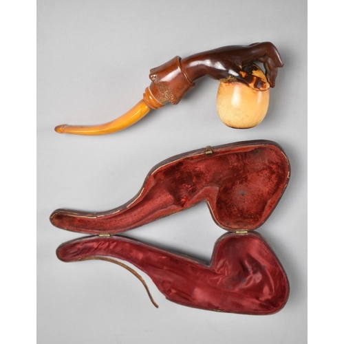 71 - A 19th Century Cased Amber and Meerschaum Pipe Modelled as a Hand Holding an Egg, 21cms Long