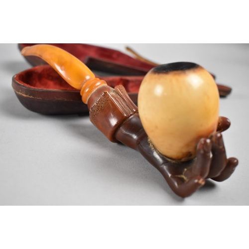 71 - A 19th Century Cased Amber and Meerschaum Pipe Modelled as a Hand Holding an Egg, 21cms Long