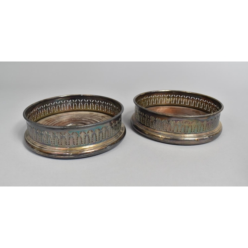 91 - A Pair of Mid 20th Century Silver Plated Bottle Coasters with Pierced Decoration, 13cms Diameter