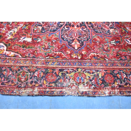 456 - A Large Antique Persian Heriz Rug on Red Ground, Some Wear and Condition Issues, 340x240cms