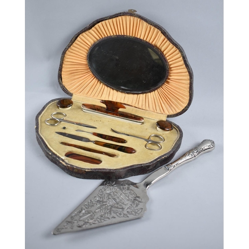 85 - A Vintage Cased Tortoiseshell Ladies Manicure Set, together with a Silver Plated Cake Slice