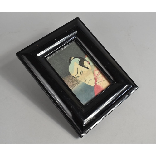 141 - A Reproduction Ebonized Photo Frame Containing Section of Chinese Actor Print, 24x19cms