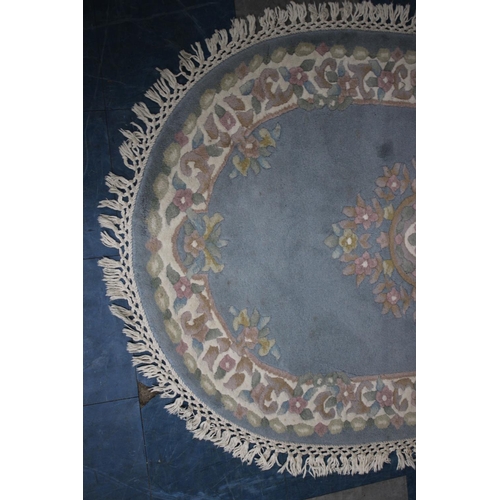 566 - A Chinese Oval Woollen Rug, 154x95cms