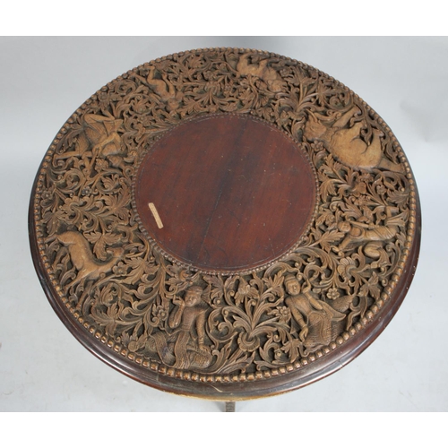 515 - An Indian Folding Table with Circular Top Having Profusely Carved Design Incorporating Elephants, Ti... 