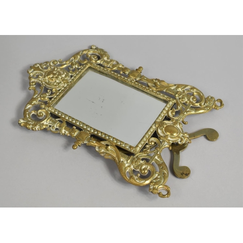 28 - A Pierced Carved Brass Easel Back Mirror, 26cms High