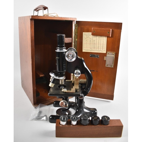 109 - A Vintage Cased Monocular Microscope with Accessories and Lenses