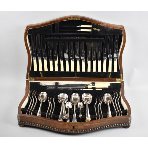 199 - An Edwardian Oak Canteen of Cutlery, the Knives with Bakelite Handles