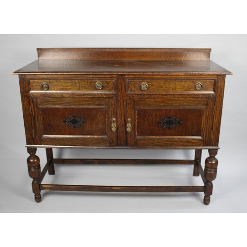 79 - An Edwardian Oak Galleried Sideboard with two Drawers over Cupboard Base, 121cms Wide