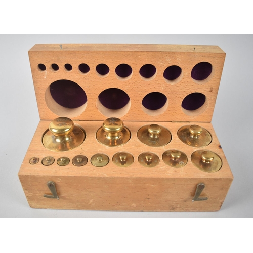 4 - A Cased Set of Graduated Brass Metric Weights of Cylindrical Form, 22cms Wide