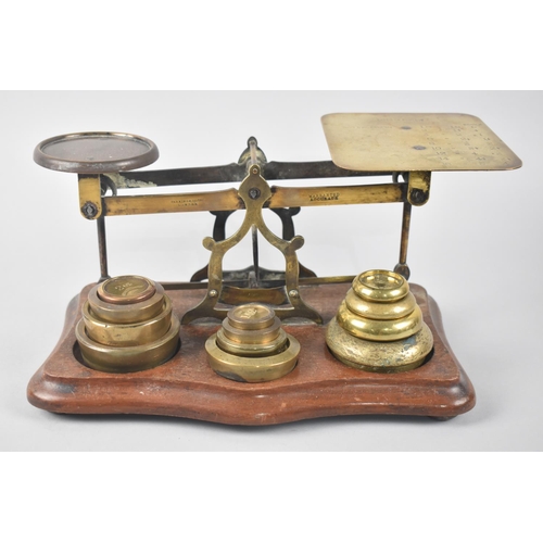 56 - A Set of Late 19th Century Brass Postage Scales with Various  Graduated weights on Serpentine Mahoga... 