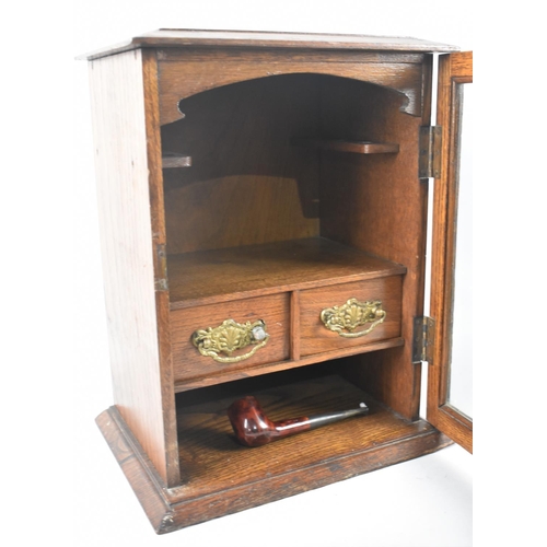 8 - An Edwardian Oak Glazed Smokers Cabinet with Two Inner Drawers, 28cms Wide