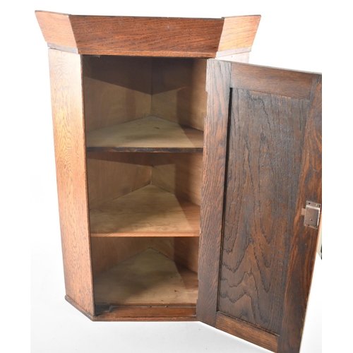 115 - A Narrow Oak Hanging Corner Cabinet with Panelled Door to Shelved Interior, 41cms Wide and 69cms Hig... 