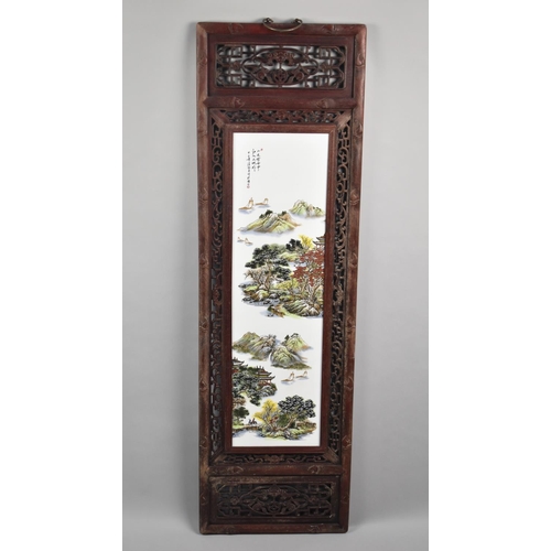 186 - An Oriental Wooden Framed Porcelain Panel, 120cms by 36cms