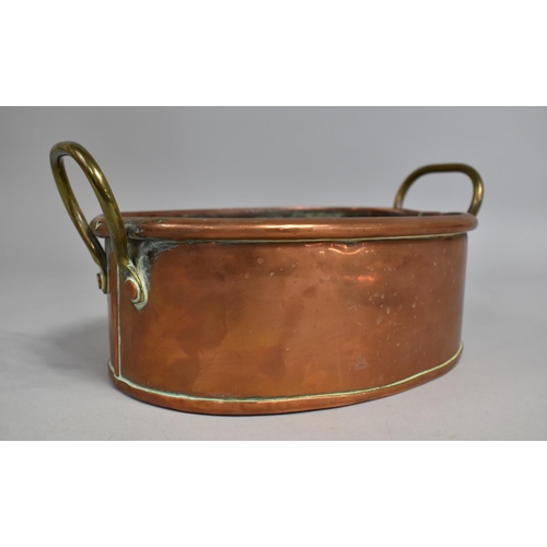 73 - A Late 19th/Early 20th Century Copper Oval Cooking Pan with Brass Handles together with a Late 19th ... 