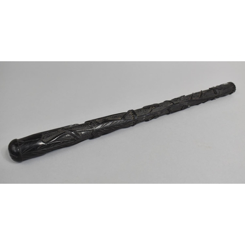 42 - A 19th Century Carved and Tapering Irish Bog Oak Priest, 36cms Long