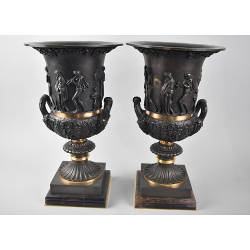 74 - A Pair of Heavy Patinated and Gilt Bronze French Style Two Handled Urns on Stepped Plinths, Bodies D... 