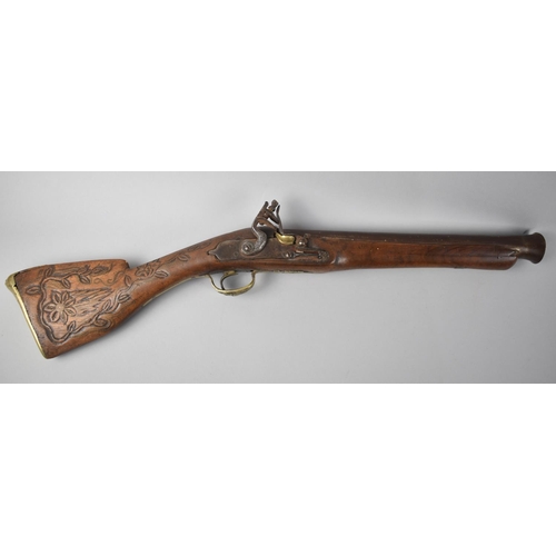 93 - A Continental Brass Mounted Flintlock Blunderbuss with Carved Stock, 60cms Long