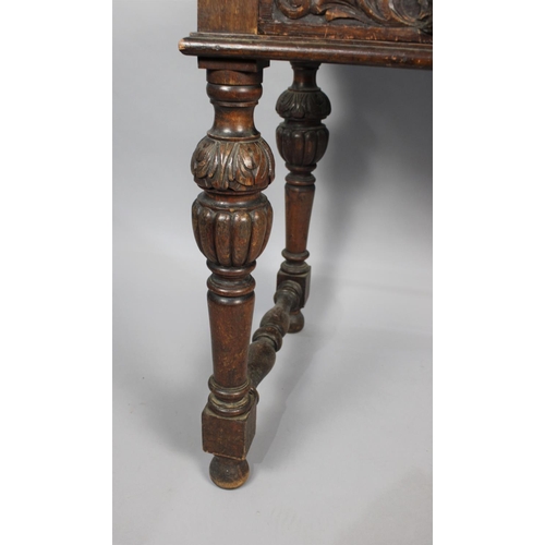 110 - A Late Victorian Gothic Revival Side Table with Two Carved Drawers and Carved Bulbous Supports, Inse... 