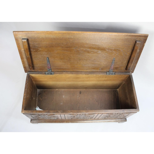 158 - A Mid 20th century Oak Lift Top Carved Fronted Blanket Box, 94cms Wide