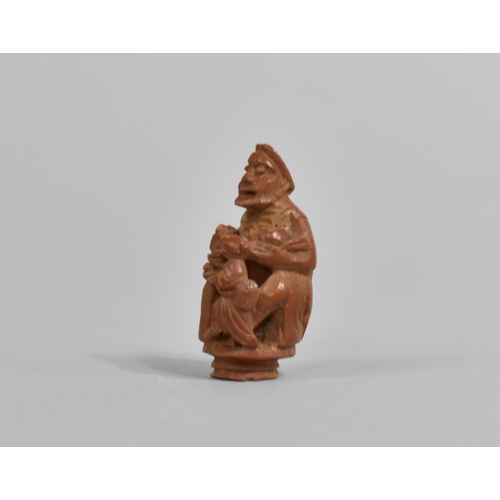 246 - A 19th Century Chinese Carved Hediao Nut in the Form of an Eldar and Child, 4cms High