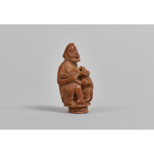 246 - A 19th Century Chinese Carved Hediao Nut in the Form of an Eldar and Child, 4cms High