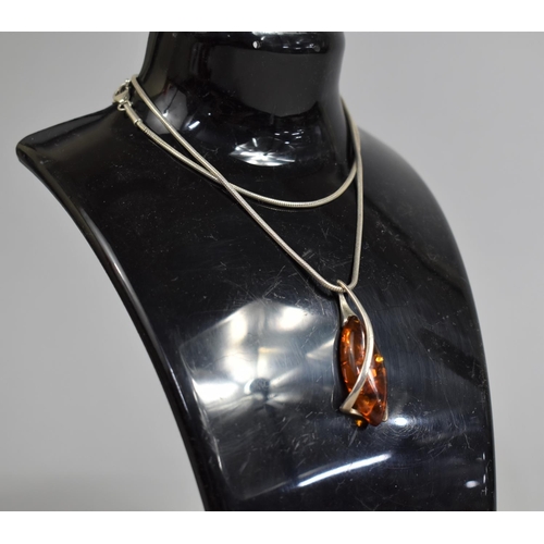 393 - A Silver and Amber Pendant on Silver Chain