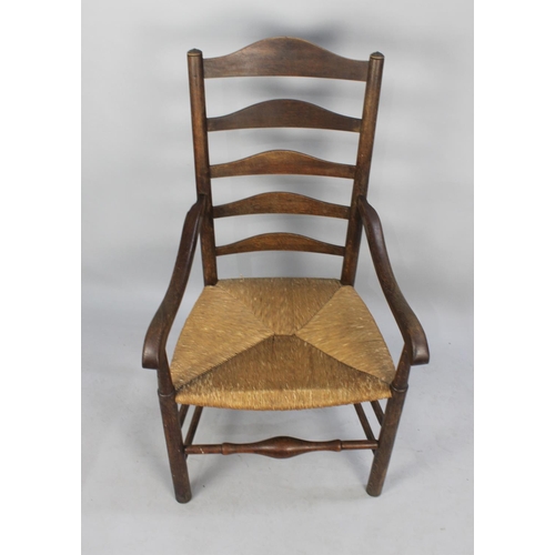 482 - A Late 19th/Early 20th Century Oak Framed Ladder Back Armchair with Rush Seat