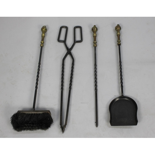 84 - A Mid 20th Century Wrought Iron and Brass Companion Set of Long Handled Fire Irons