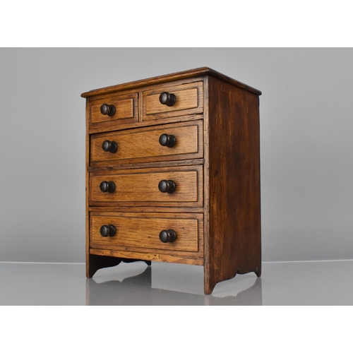 23 - A Late 19th Century Oak Apprentice Chest of Two Short and Three Graduated Long Drawers. 19.5cms Wide... 