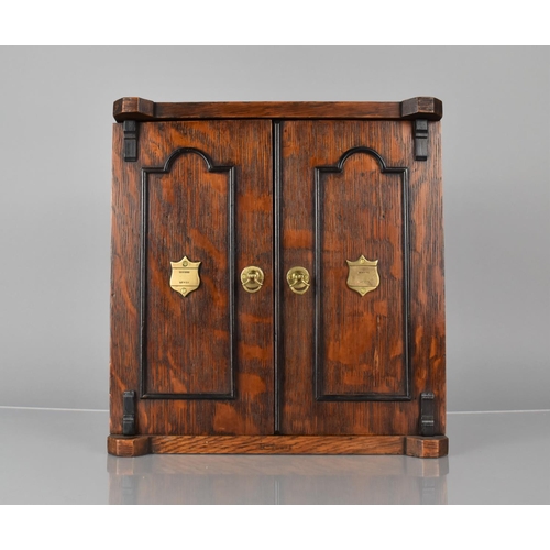 51 - A Late 19th/Early 20th Century Oak Smoker's Cabinet having Panelled Doors with Brass Handles and Loc... 