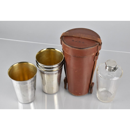 60 - A Good Quality Leather Cased Drinking Set comprising Glass Spirit Flask and Four Regent Plate Beaker... 