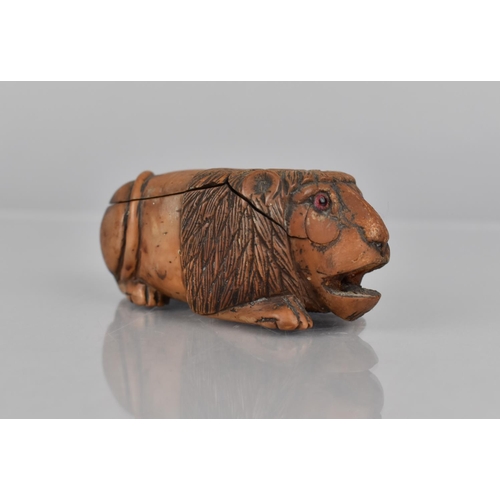 85 - A 19th Century Coquilla Nut Snuff in the Form of a Lion, 8cms Long. Condition: Not in perfect order ... 