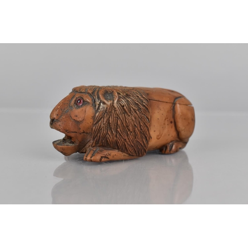 85 - A 19th Century Coquilla Nut Snuff in the Form of a Lion, 8cms Long. Condition: Not in perfect order ... 