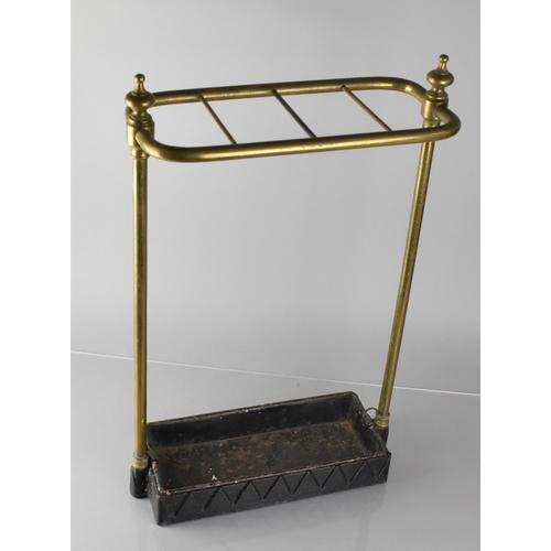 173 - An Early 20th Century Brass Four Section Stick Stand with Iron Base and Drip Tray, 36cms Wide and 61... 