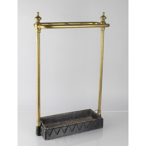 173 - An Early 20th Century Brass Four Section Stick Stand with Iron Base and Drip Tray, 36cms Wide and 61... 