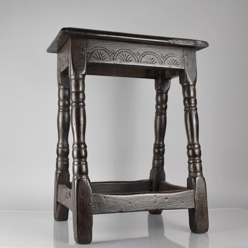 201 - An 18th Century Oak Peg Jointed Stool with Carved Seat Rail and Four Turned Supports, Top 45x25cms